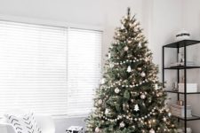 07 a modern Scandinavian tree with pompom ball garlands, metallic ornaments and tree-shaped ornaments plus lights
