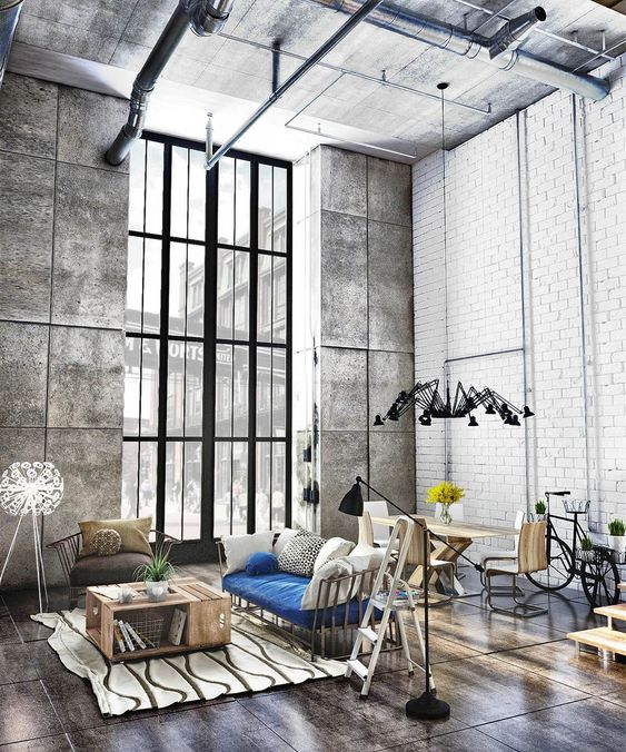 concrete on the ceiling and walls and wood on the floor set the tones in this industrial space, it's in greys and browns
