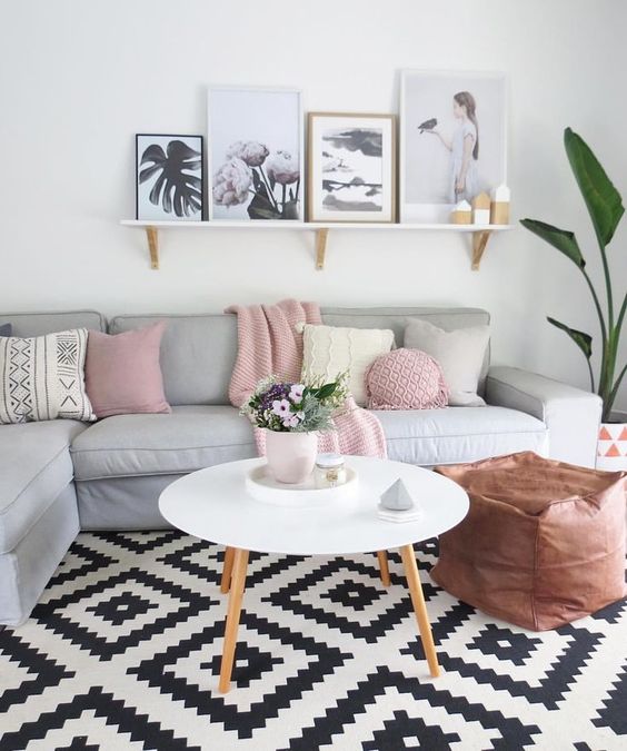 Scandinavian interiors have been dotted with color lately, like here with pink pillows and throws
