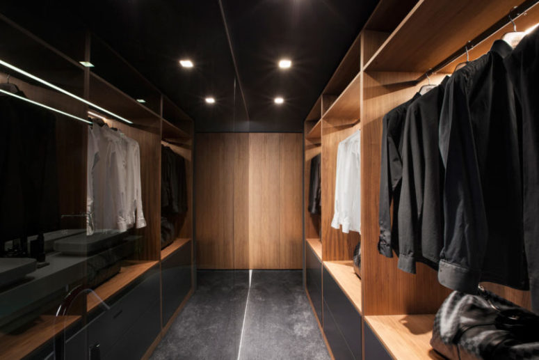 There's a comfortable closet next to the bedroom, done in the same color and material palette
