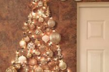 08 a glam wall-mounted Christmas tree done with lights and white and silver ornaments of various shapes over the mantel