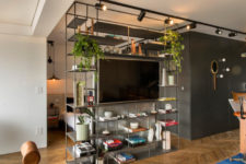 09 The floor to ceiling shelving unit divides the spaces and hides the sleeping zone