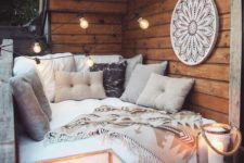 09 a small and cozy sofa, lots of pillows and throws, large candle lanterns and an oversized dream catcher
