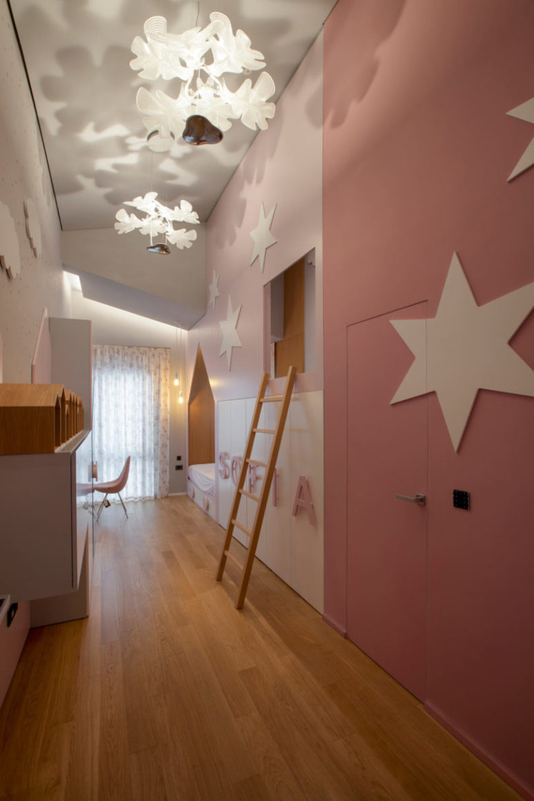 The kid's room is done in pink and white, though it's rather long and narrow, there's everything necessary