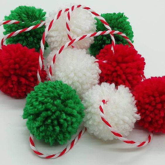 a pompom garland in traditional Christmas color and with a striped string will be a budget-savvy and fun decoration