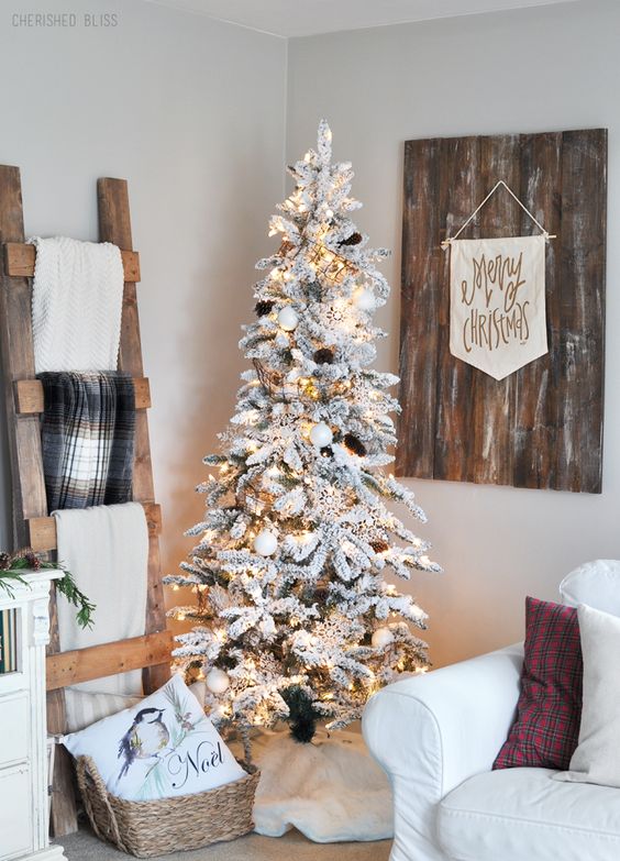 white ornaments, lights and pinecones make the flocked tree look very natural and will be ideal for Scandi interiors