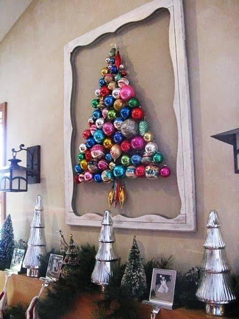 a colorful ornament Christmas tree formed right on the wall and highlighted with a vintage frame is a creative idea