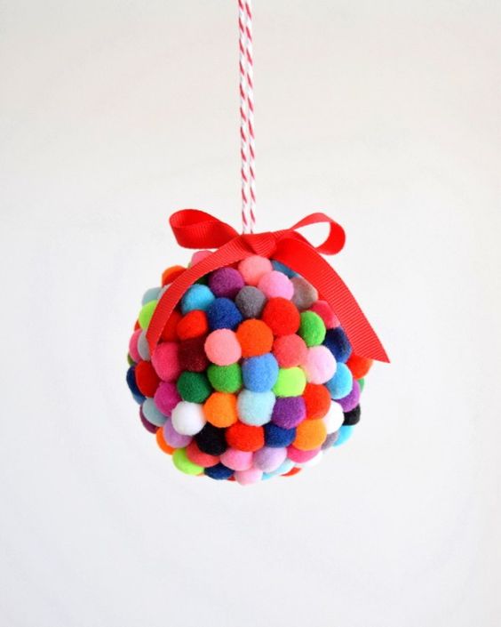 a colorful small pompom ornament with a bow on top is a fun idea to decorate your Christmas tree
