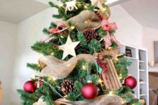12 a gorgeous rustic Christmas tree with pinecones, wooden stars and sledges, red balls and plaid bows, a star on top
