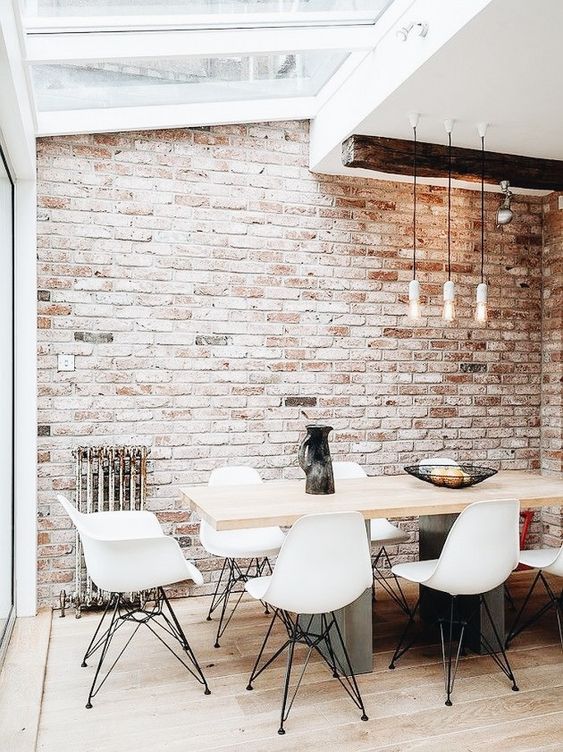 an all-neutral space spruced up with a single vintage brick wall  and a vintage metal stand