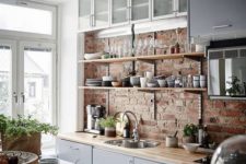 12 an exposed brick wall and wooden countertops for a modern rustic kitchen