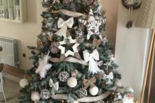 13 a beautiful rustic Christmas tree with burlap bows and ribbons, fluffy snowflakes, bows, vine ornaments and yarn balls