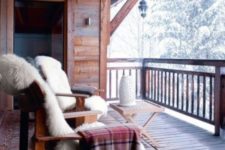13 a couple of wooden chairs covered with faux fur, plaid blankets and a small folding table plus a gorgeous view