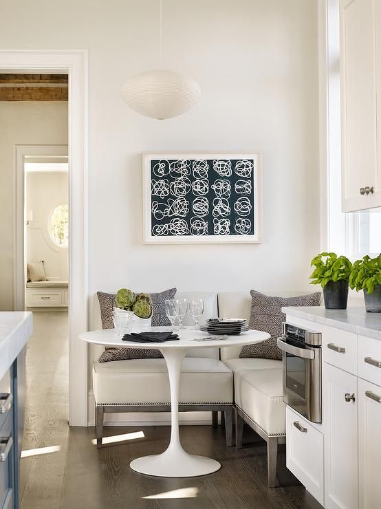 a cozy eat-in kitchen nook with an L-shaped bench and a round small table is what you need for breakfasts