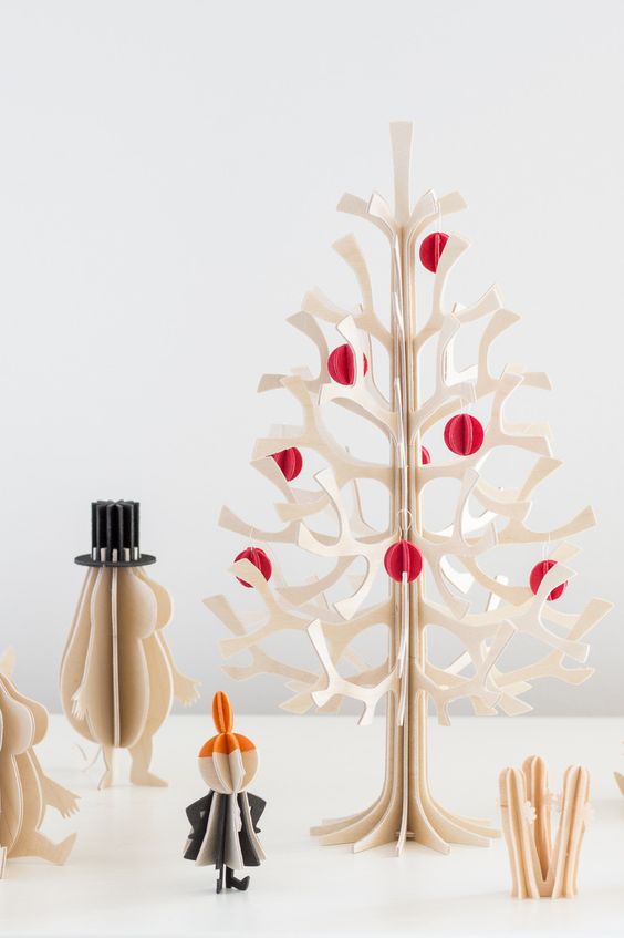 a laser cut plywood Christmas tree with colorful 3D paper ornaments is a cool table version