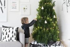 13 a modern Nordic tree with lights and white tree-shaped ornaments plus geometric ones