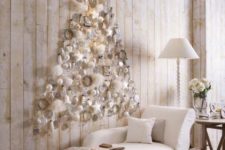 13 a subtle white Christmas tree of white ornaments and fluffs plus a star on top is realized right on the wall