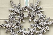 14 a Christmas wreath made of snowy pinecones and ribbon is a super creative and interesting idea