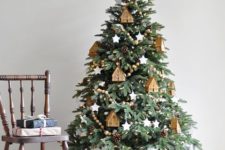 14 a cozy Christmas tree with wooden bead garlands, wooden tree ornaments and pinecones plus lights all over