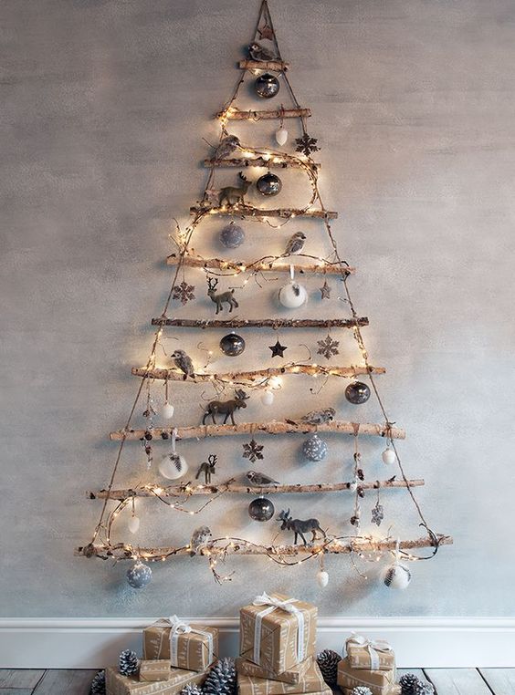 a simple Christmas tree of branches decorated with lights and neutral ornaments for a rustic feel in your space