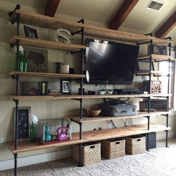 an industrial shelf unit of pipes and wood is ideal for lofts and other industrial spaces