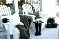 15 a duo of wooden chairs with pillows, blankets and faux fur, potted plants and a whitewashed deck for a Nordic touch