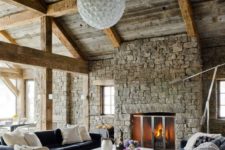 15 much stone, wooden beams and comfortable modenr furniture upholstered with velvet and a cowhide rug