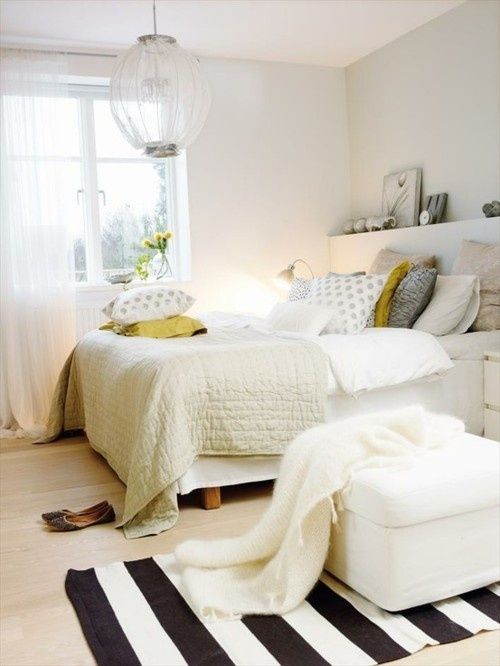 a gender neutral bedroom in neutrals with much texture and touches of yellow that fit both men and women easily
