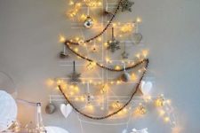 16 attach some wire or yarn right to the wall, add ornaments to shape a tree and add lights