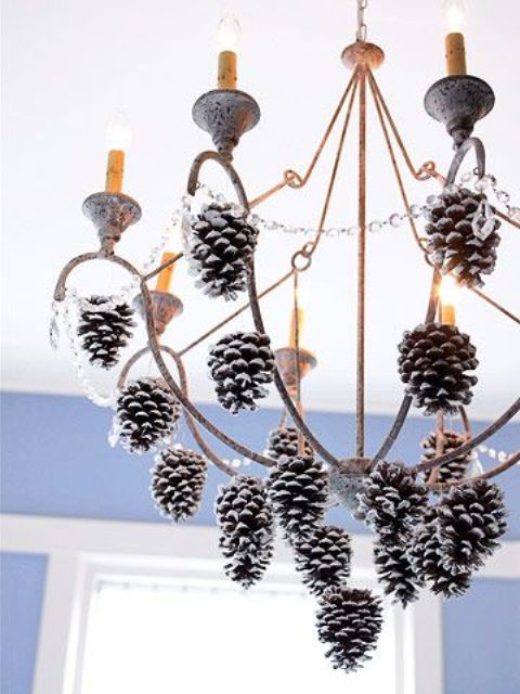 decorate your chandelier with some crystals and snowy pinecones to make it feel like Christmas at once