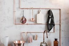 16 exposed copper piping doubles as utensil storage in this industrial kitchen