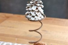 17 a snowy pinecone on a wire stand plus a usual one with evergreens cna be a nice rustic decoration