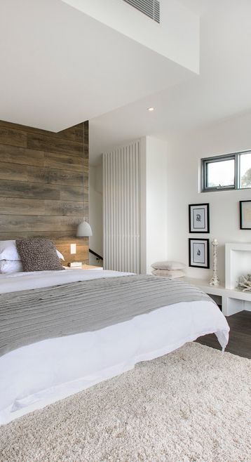 a wood wall and a fluffy rug add interest to the space and make it catchier and brighter