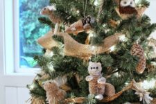 17 fake animal ornaments, gilded pinecones, jingle bells and burlap ribbons bring a strong rustic feel to the tree