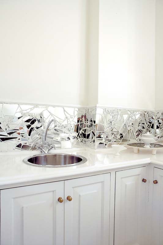 a broken mirror backsplash is a catchy feature that looks whimsy and can be easily DIYed by you