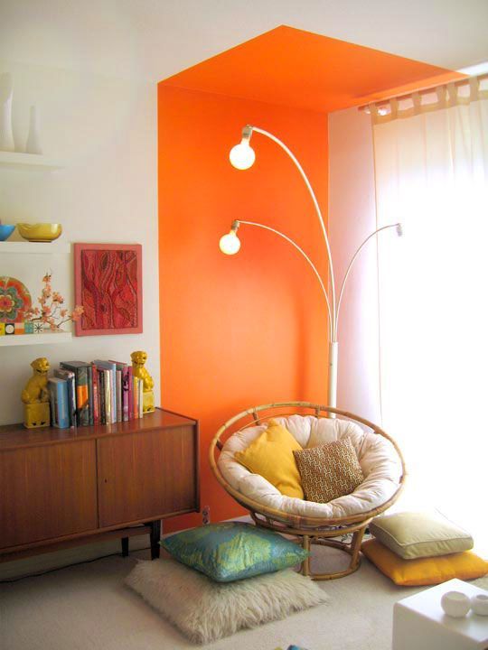lots of pillows and soft upholstery plus a colorful accent here make the reading nook special