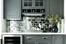 19 a graphite grey farmhouse kitchen with a mirror tile backsplash to add a touch of shine