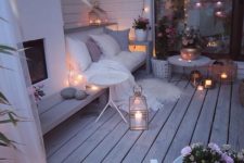 19 a super cozy winter terrace with a built-in fireplace, a bench, lights, candles, lanterns, potted flowers