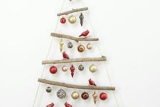 19 a super simple wall-mounted Christmas tree of branches and gold and red ornaments plus bird figurines