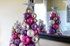 20 a duo of tabletop Christmas trees of colorful Christmas ornaments glued to each other with a silver star on top