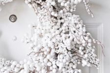 20 a gorgeous snowy Christmas wreath of fake white berries and pompoms will create a chic frozen winter look anywhere