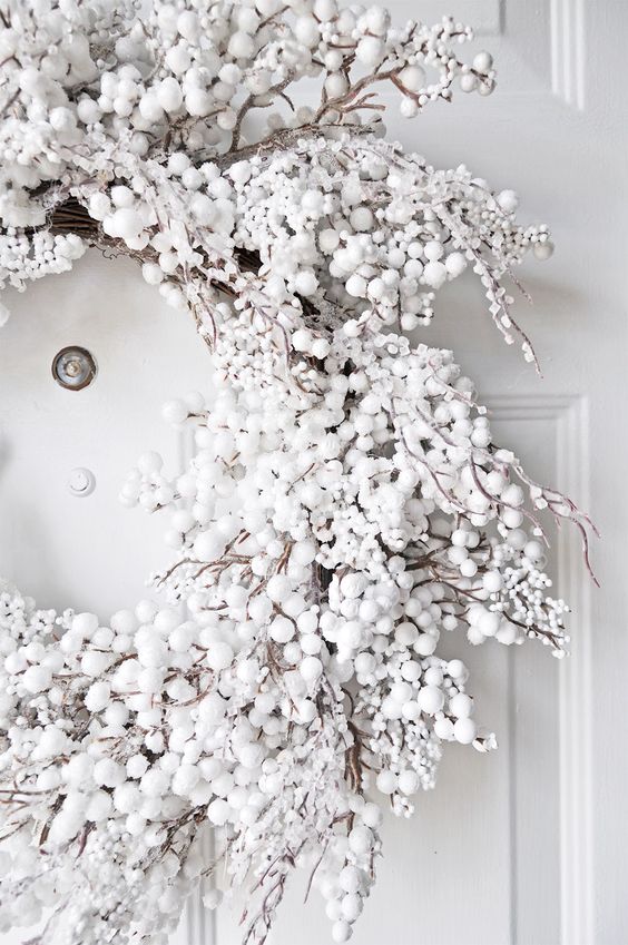 a gorgeous snowy Christmas wreath of fake white berries and pompoms will create a chic frozen winter look anywhere