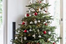 20 a traditional Christmas tree with white, red, metallic ornaments, balls, snowflakes and stars