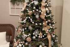 21 a chic Christmas tree with white snowflakes, ball ornaments, twigs, pompomg garlands, burlap ribbons and vine ornaments