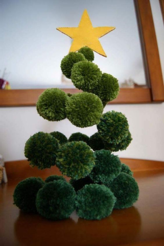a fun green pompom Christmas tree made on wire with a gold felt star on top is a great alternative to a usual tree
