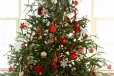 21 a traditional Nordic Christmas tree with metallic, red and white ornaments of various shapes and letters plus lights