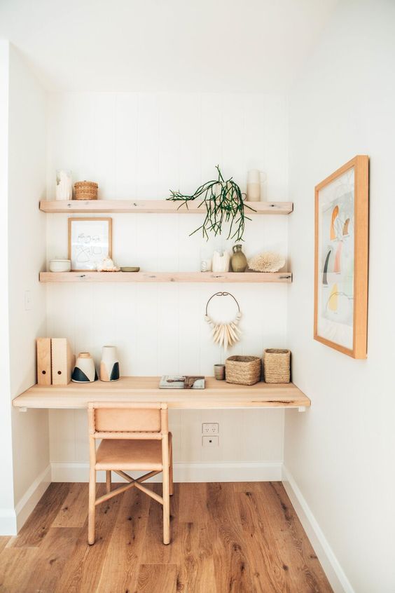 a wooden floor, shelf desk and shelves cozy up this home office nook at once