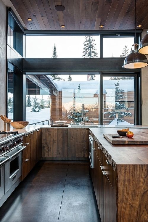 a modern rustic kitchen with stained wooden cabinets, ceiling and floor is a fine example of the style