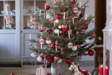 22 a traditional Nordic Christmas tree with white, red and silver ornaments and candy canes as decorations