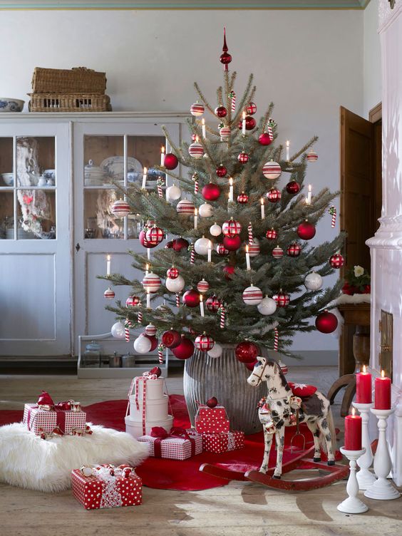 a traditional Nordic Christmas tree with white, red and silver ornaments and candy canes as decorations